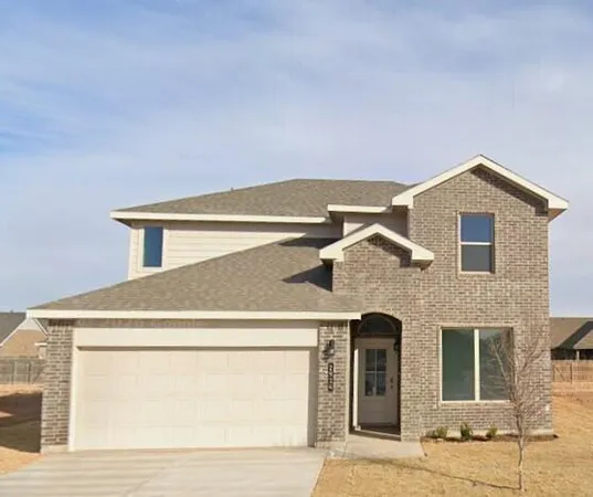 a front view of a house with garage