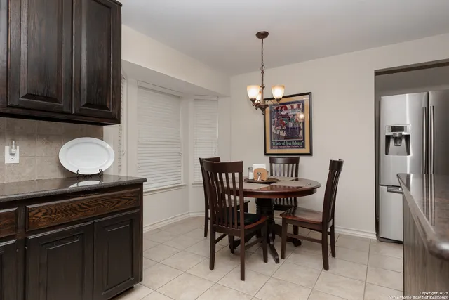 a dining room with furniture and window