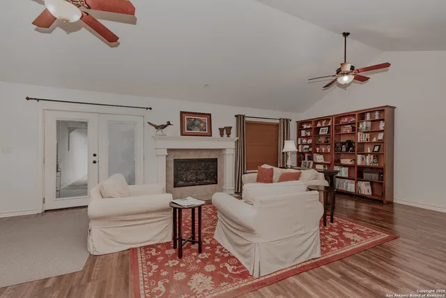 a living room with furniture a fireplace and a table