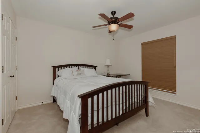 a bedroom with bed and a window