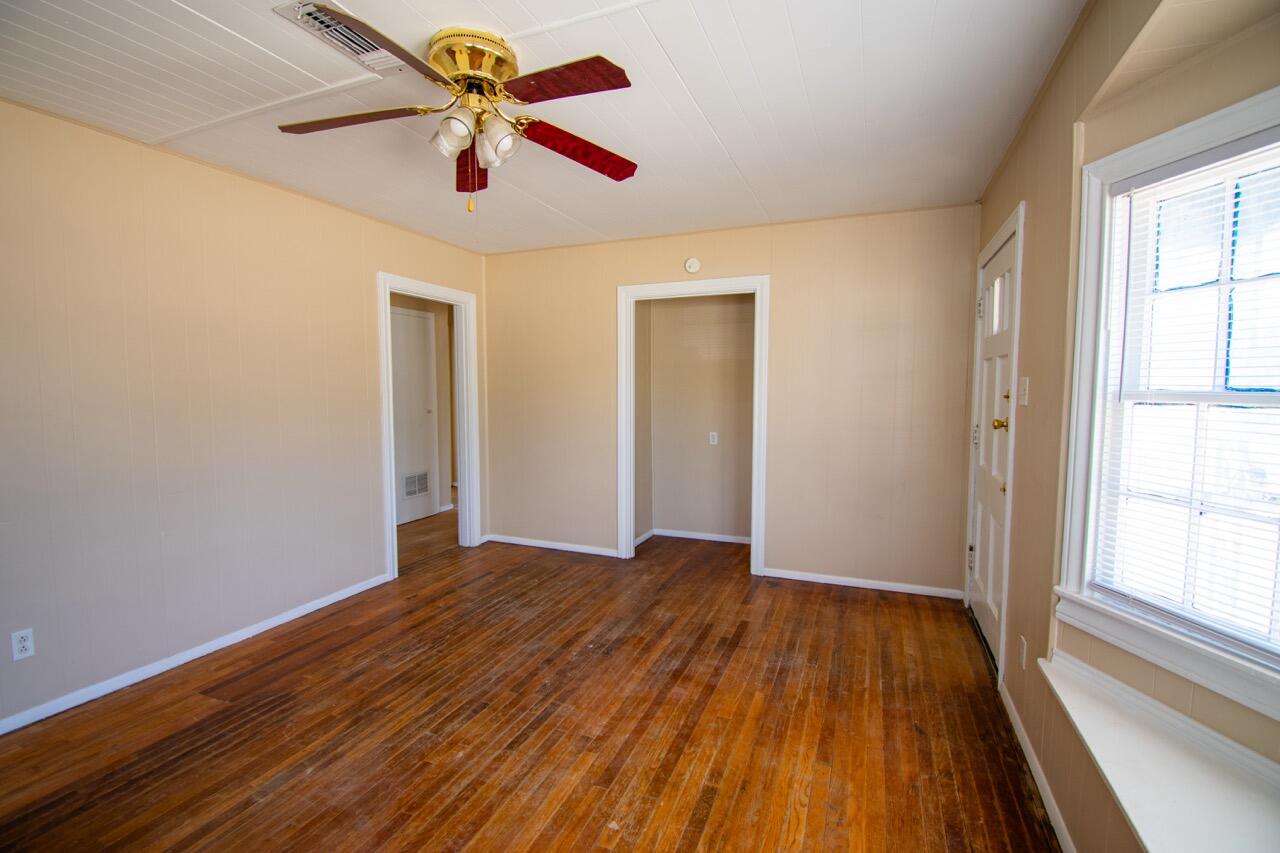 2424 27th Street Lubbock, TX 79411 - Photo 4 of 14 a view of empty room with wooden floor and fan