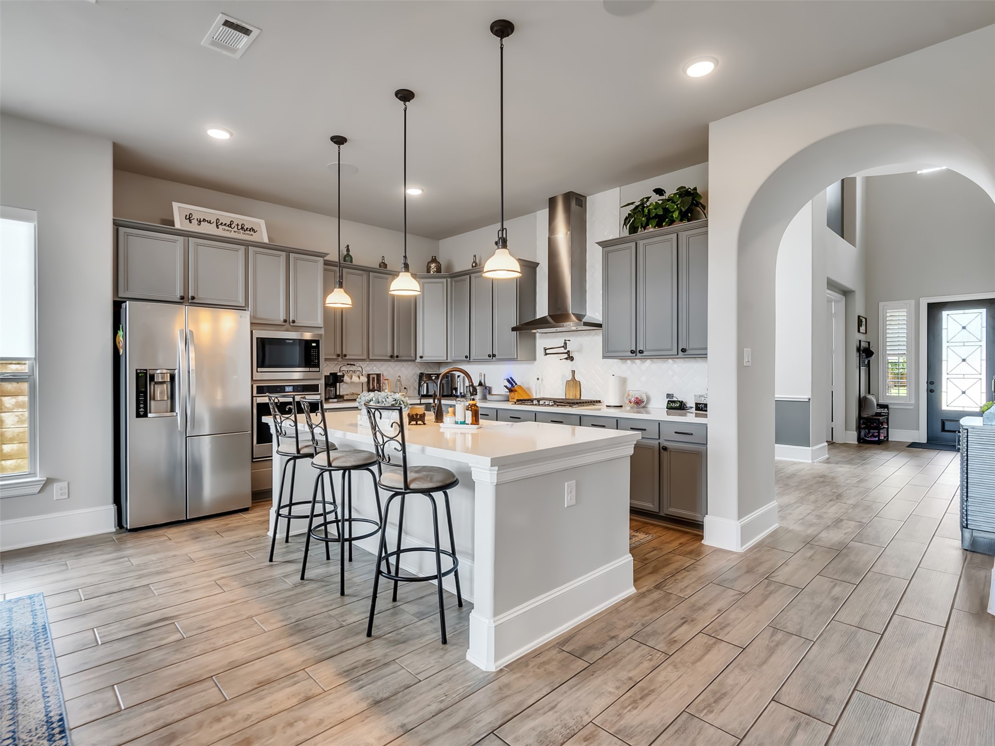 10302 Muir Peak Drive Rosharon, TX 77583 - Photo 11 of 40 Stainless steel appliances, bar seating, and pendant lighting make this kitchen brilliant.