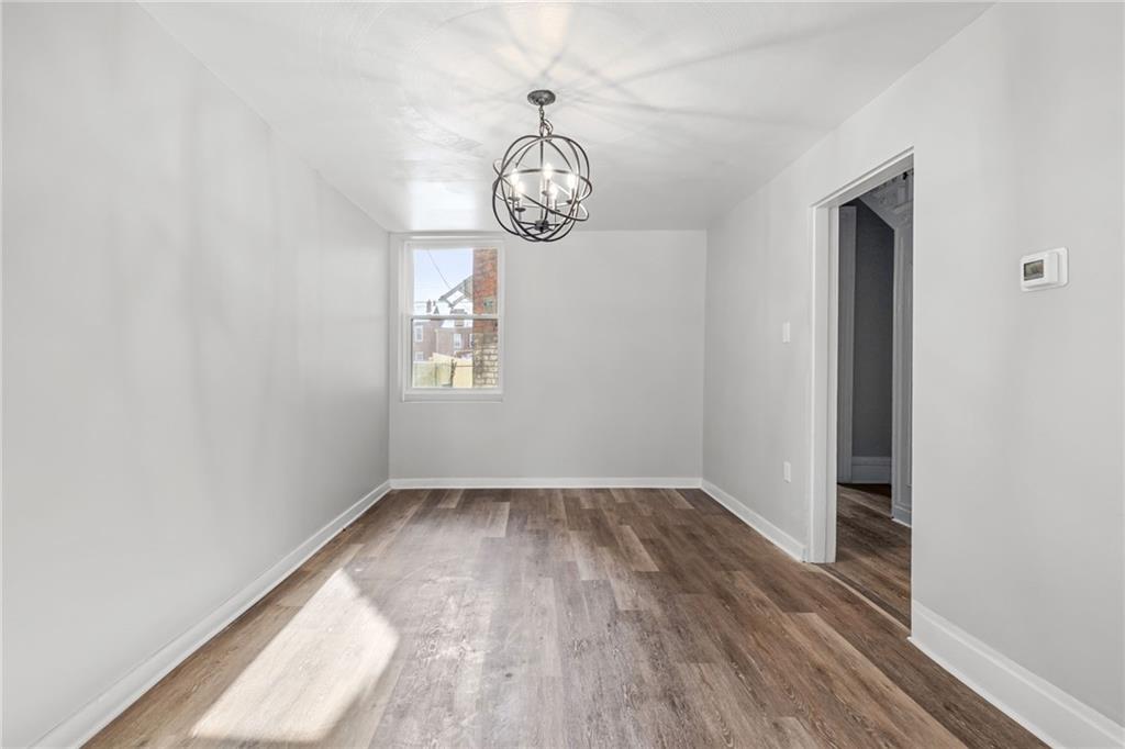 1319 Adams Street Pittsburgh, PA 15233 - Photo 11 of 27 a view of a room with wooden floor and window
