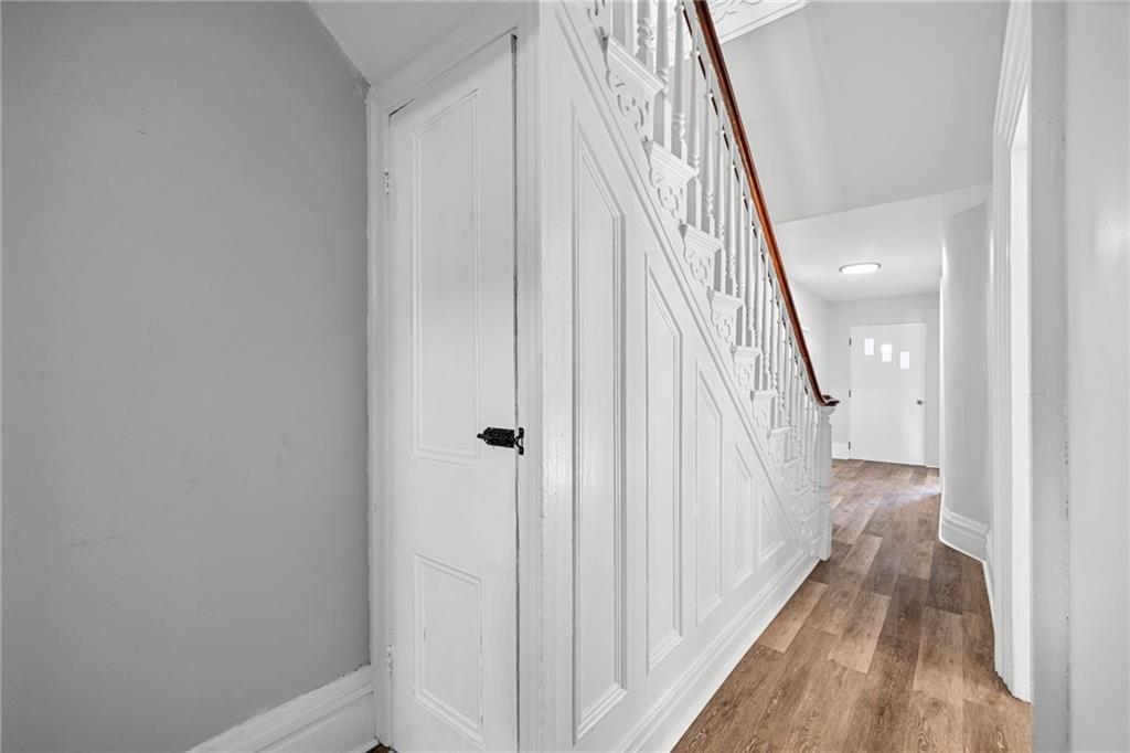 1319 Adams Street Pittsburgh, PA 15233 - Photo 16 of 27 a view of a hallway with wooden floor and staircase