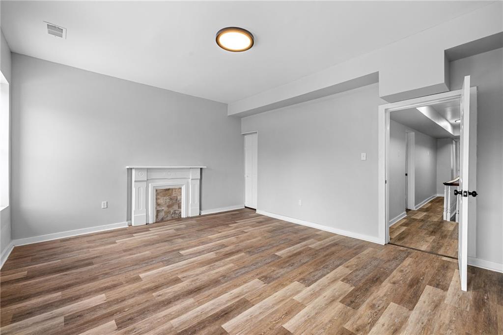 1319 Adams Street Pittsburgh, PA 15233 - Photo 19 of 27 a view of a livingroom with wooden floor and a ceiling fan
