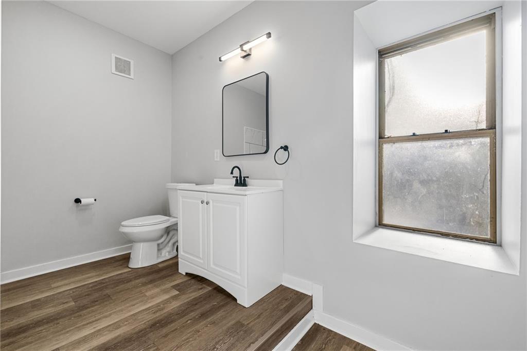 1319 Adams Street Pittsburgh, PA 15233 - Photo 21 of 27 a bathroom with a toilet sink and mirror