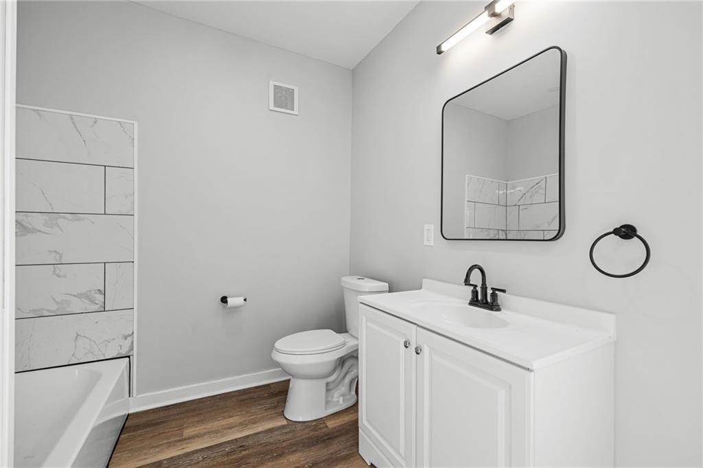 1319 Adams Street Pittsburgh, PA 15233 - Photo 22 of 27 a bathroom with a toilet sink and mirror