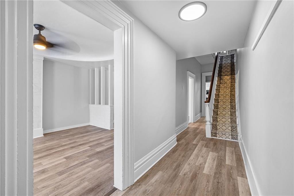 1319 Adams Street Pittsburgh, PA 15233 - Photo 5 of 27 a view of a hallway with wooden floor and staircase