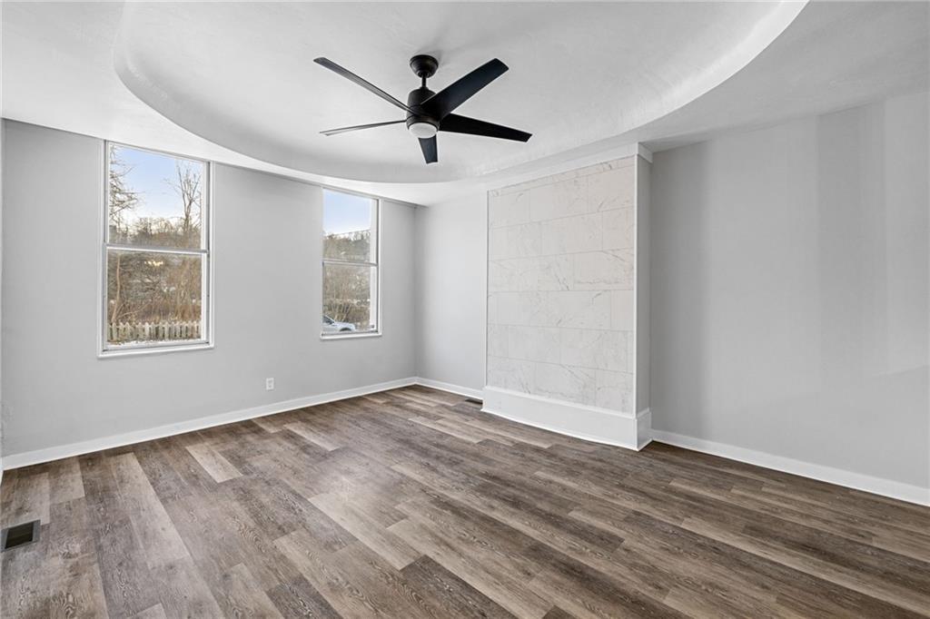 1319 Adams Street Pittsburgh, PA 15233 - Photo 9 of 27 wooden floor in an empty room with a window