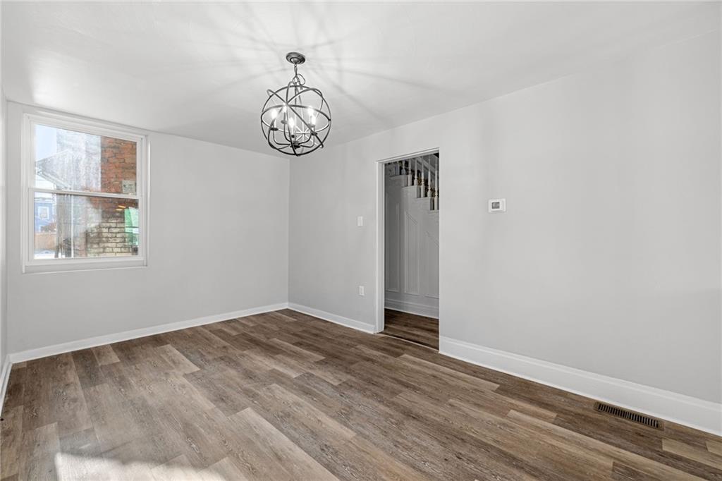 1319 Adams Street Pittsburgh, PA 15233 - Photo 10 of 27 a view of an empty room with wooden floor and a window