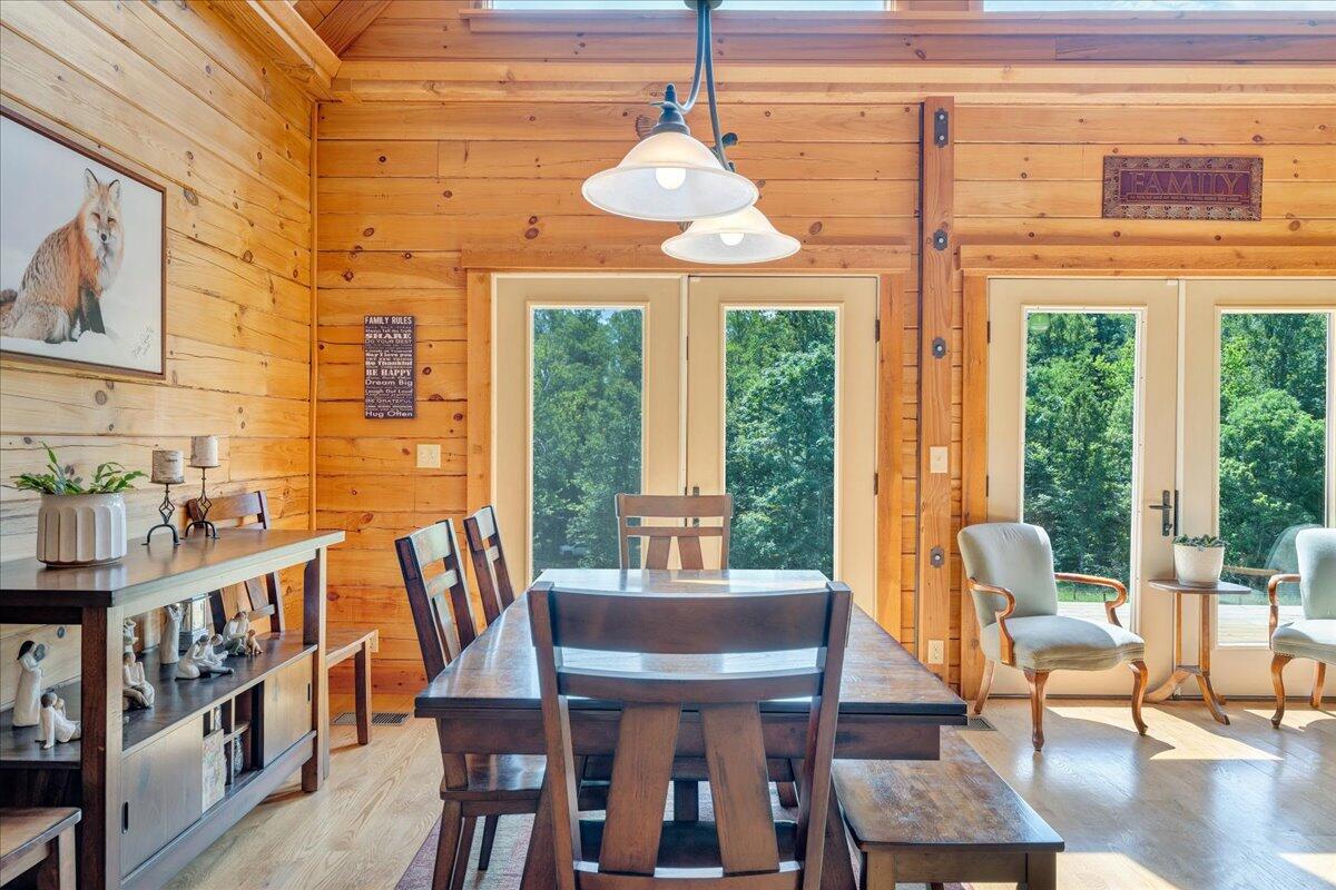 1769 Scenic View Road Moneta, VA 24121 - Photo 15 of 104 a dining room with furniture a chandelier and wooden floor