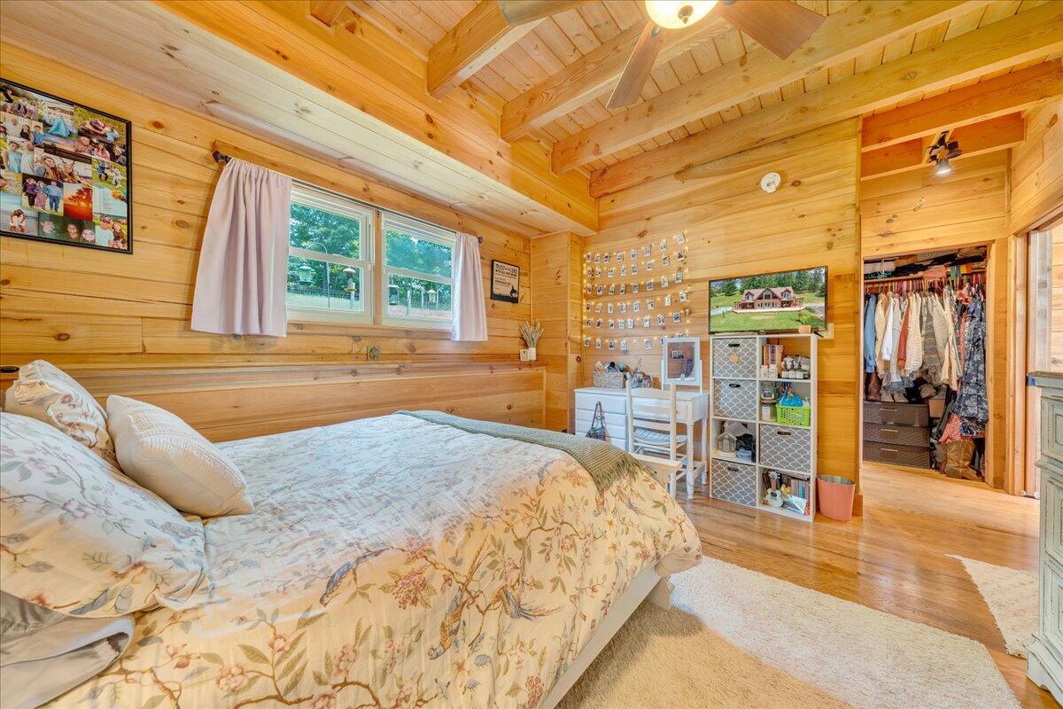 1769 Scenic View Road Moneta, VA 24121 - Photo 27 of 104 a spacious bedroom with a large bed a chandelier and a window