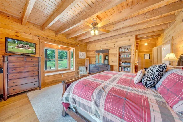 a view of a house with a big yard potted plants and large tree