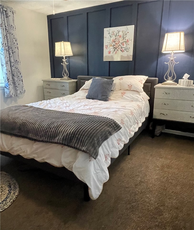 360 Ridge Street Piqua, OH 45356 - Photo 21 of 46 This cozy bedroom offers a tranquil retreat with inviting ambiance and comfortable flooring.