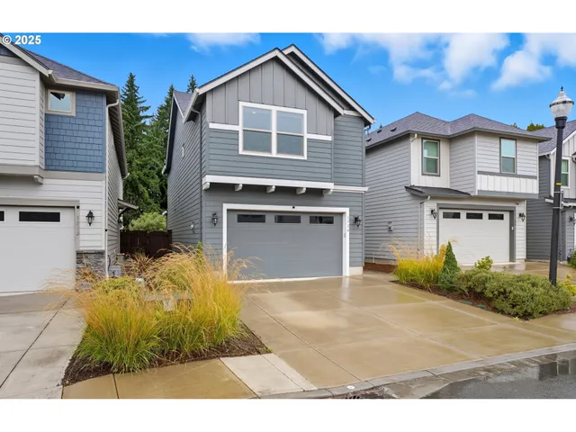 a view of a yard in front of a house with garage