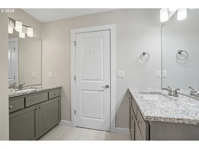 a bathroom with a granite countertop sink a mirror and a
