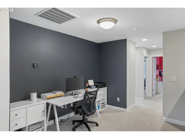 a view of a workspace area with furniture