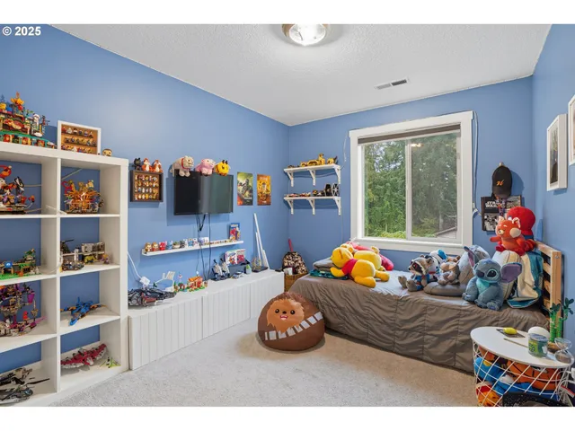 a bedroom with lots of furniture and baby bed