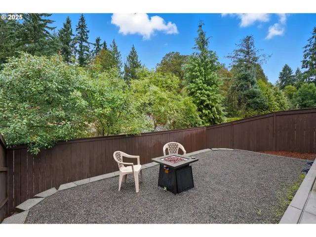 a backyard of a house with table and chairs