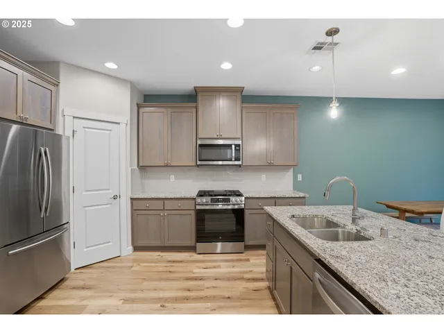 a kitchen with a sink stove and refrigerator