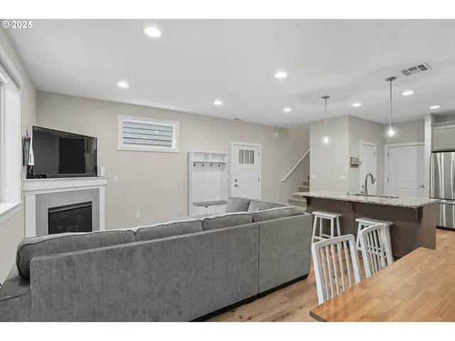 a open kitchen with kitchen island a sink stainless steel appliances and cabinets