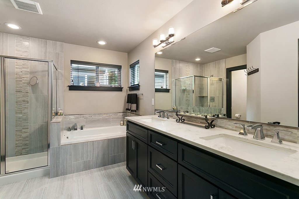 19313 Meridian Drive Southeast Bothell, WA 98012 - Photo 14 of 20 a bathroom with a double vanity sink a mirror and a shower