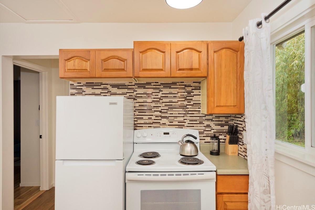 18-2274 Laulea Road Volcano, HI 96785 - Photo 4 of 15 Kitchen featuring full-size appliances and ample cabinetry, designed for everyday functionality in this Volcano HI property