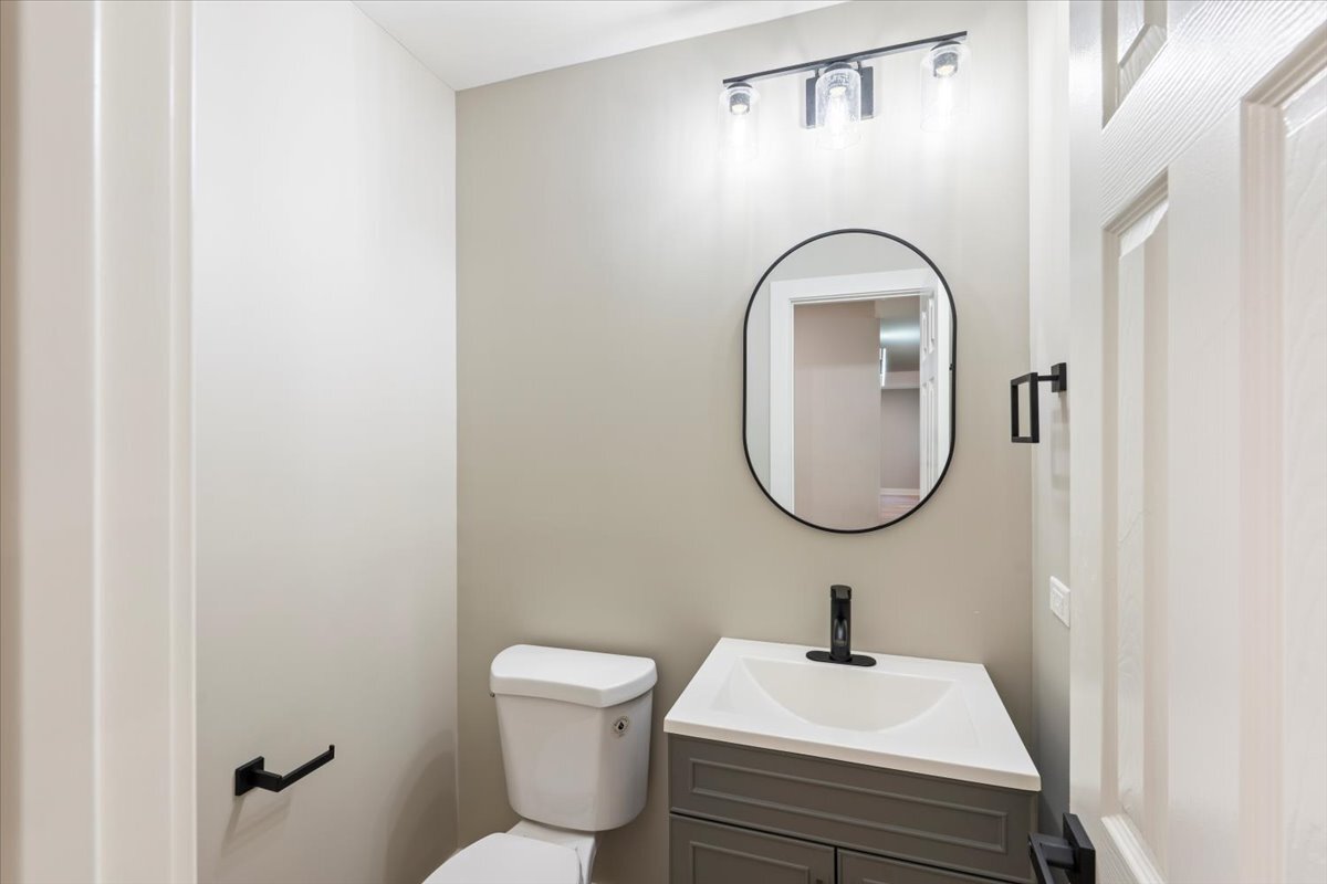 835 Ridge Avenue, Unit 207 Evanston, IL 60202 - Photo 7 of 18 a bathroom with a sink a mirror and a toilet