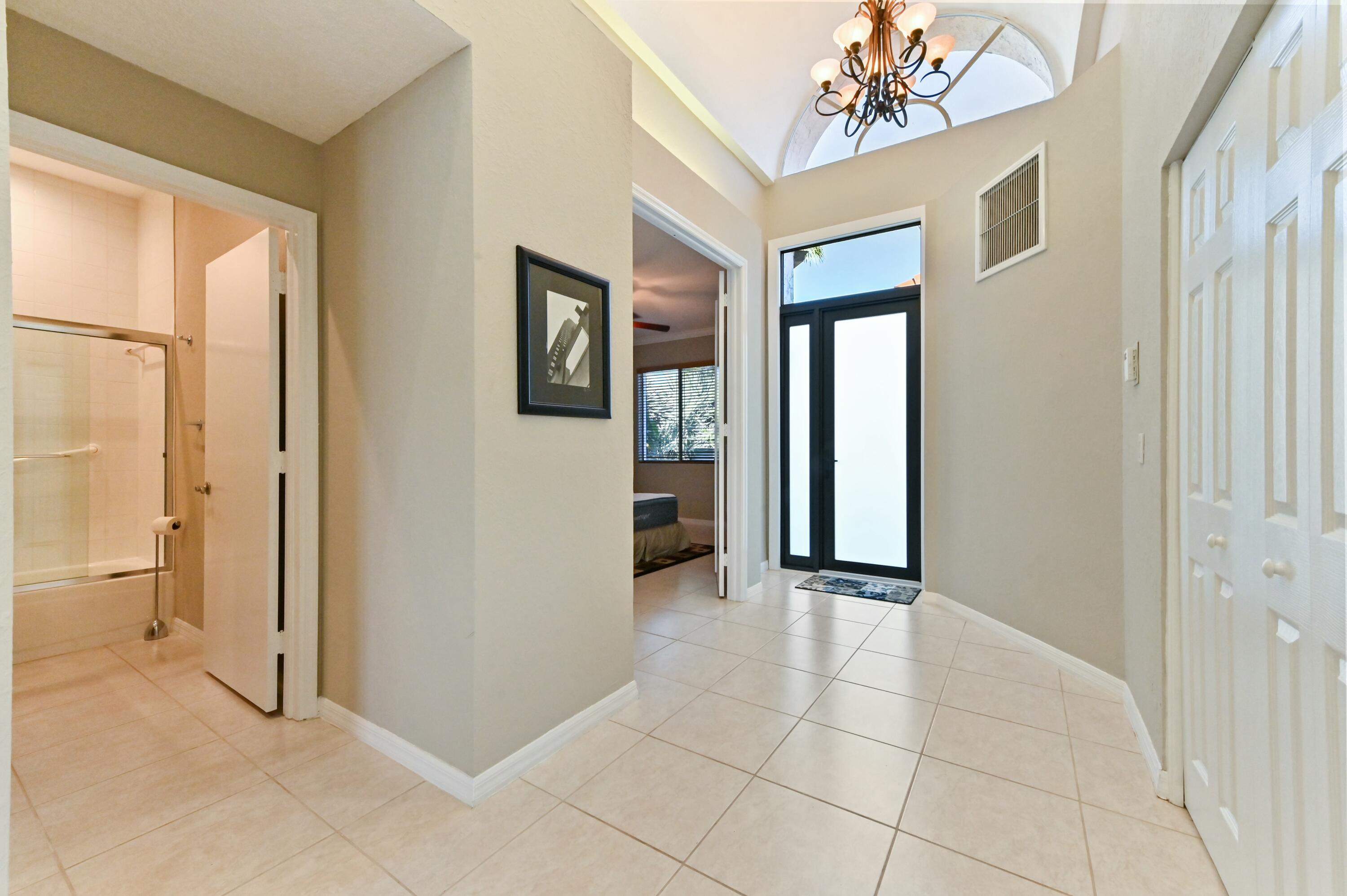 17272 Hampton Boulevard Boca Raton, FL 33496 - Photo 11 of 33 a view of a hallway with wooden shelves