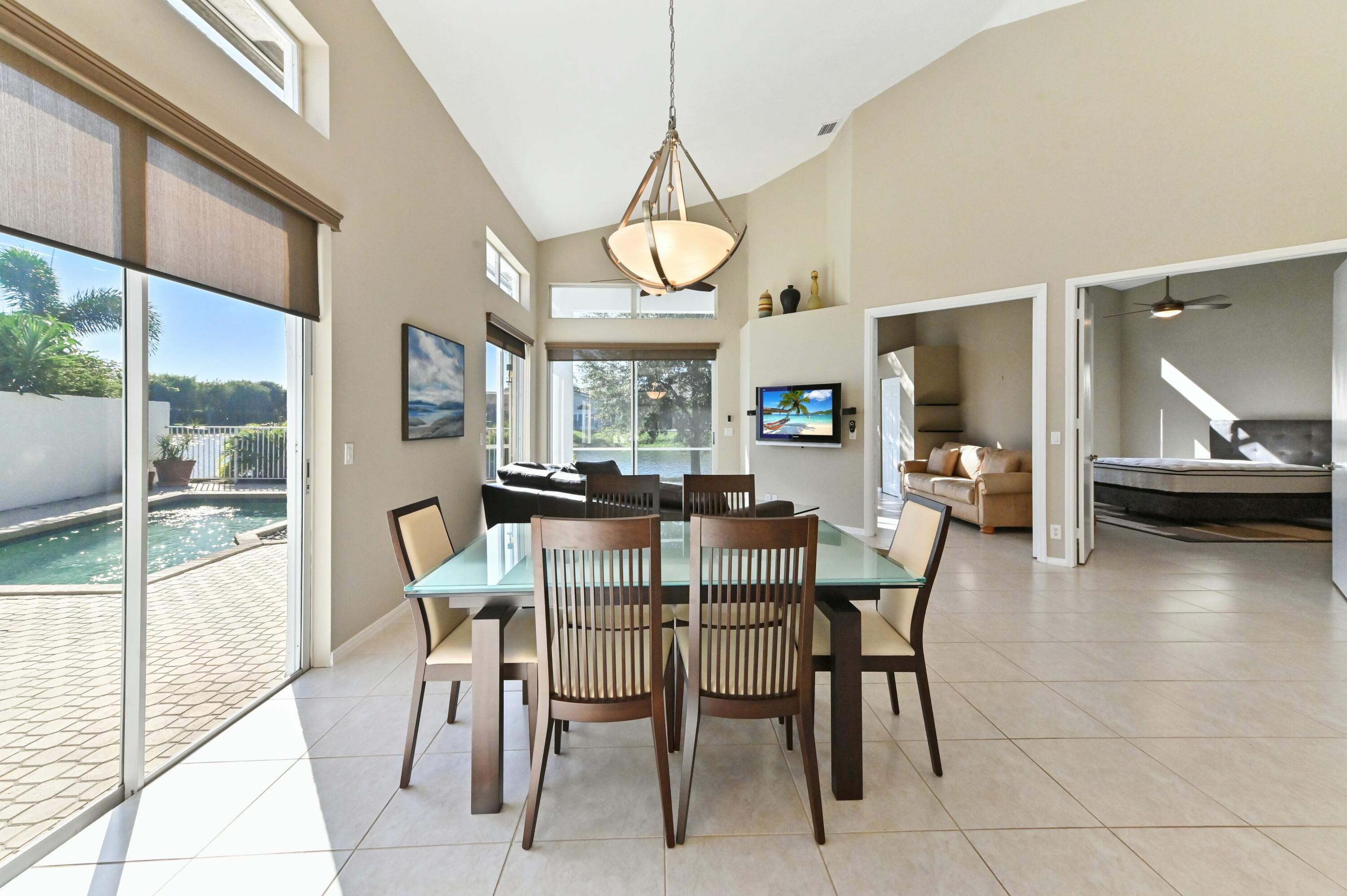 17272 Hampton Boulevard Boca Raton, FL 33496 - Photo 17 of 33 a view of a dining room with furniture window and wooden floor