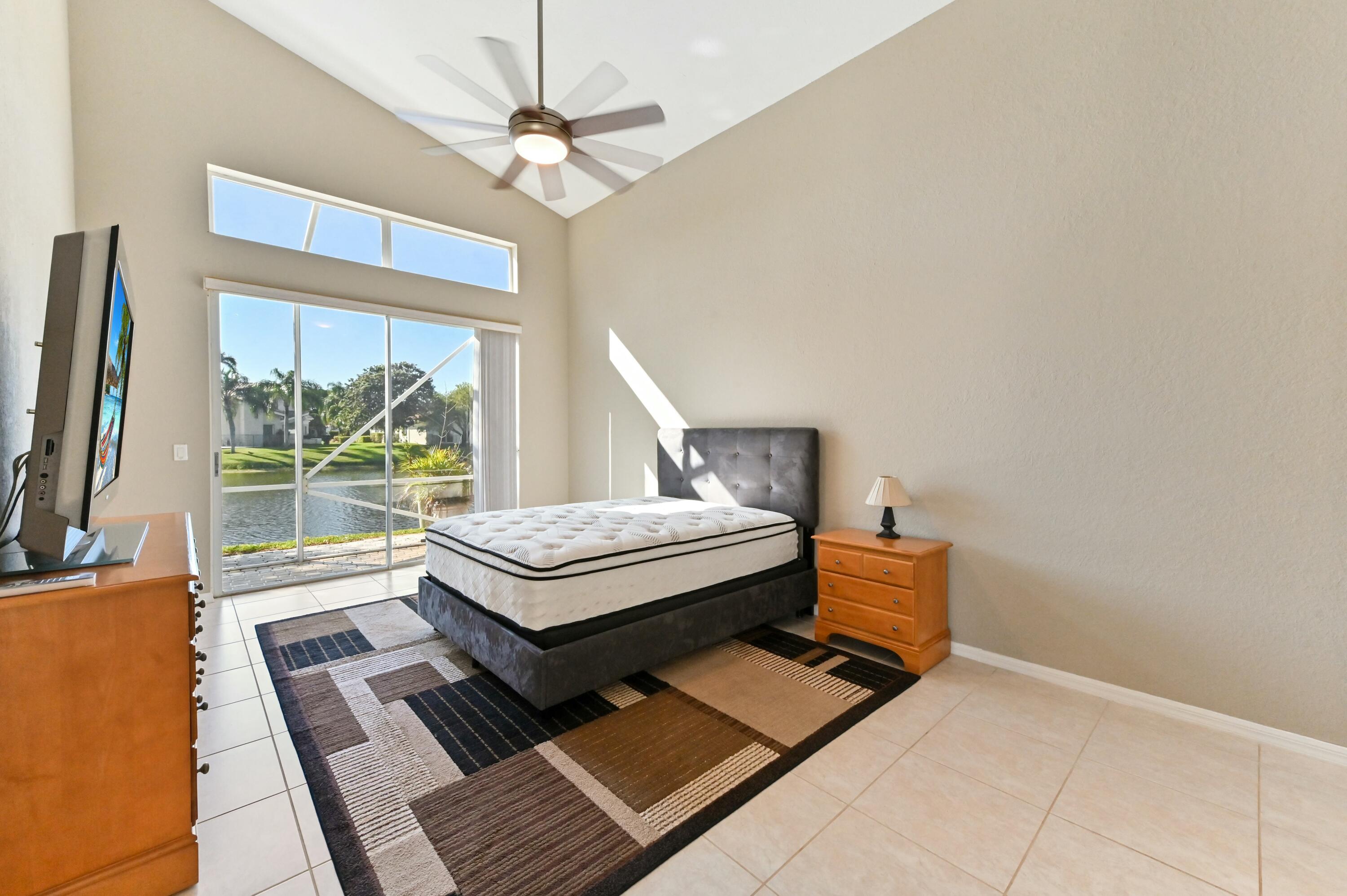 17272 Hampton Boulevard Boca Raton, FL 33496 - Photo 21 of 33 a bedroom with furniture and a large window