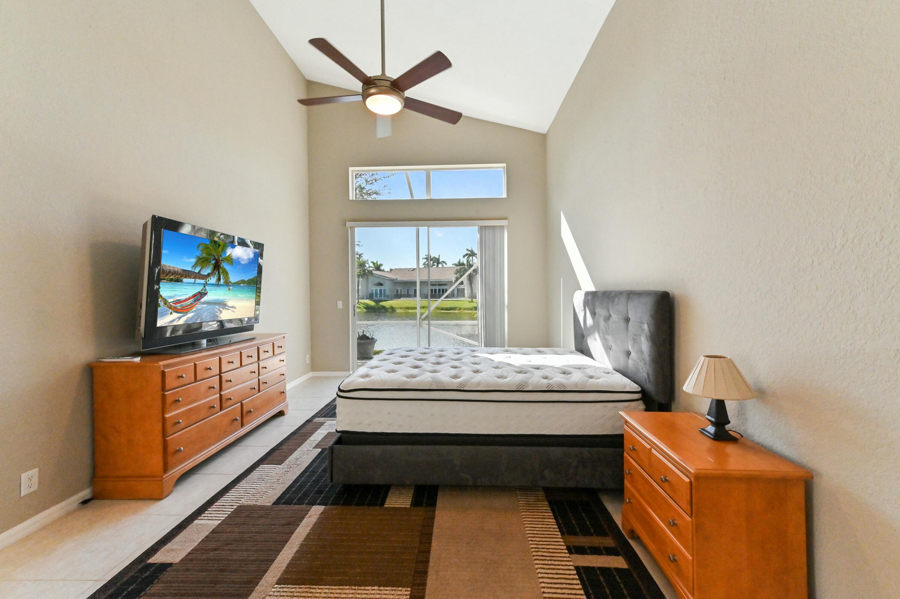 17272 Hampton Boulevard Boca Raton, FL 33496 - Photo 22 of 33 a bedroom with a bed and a flat screen tv