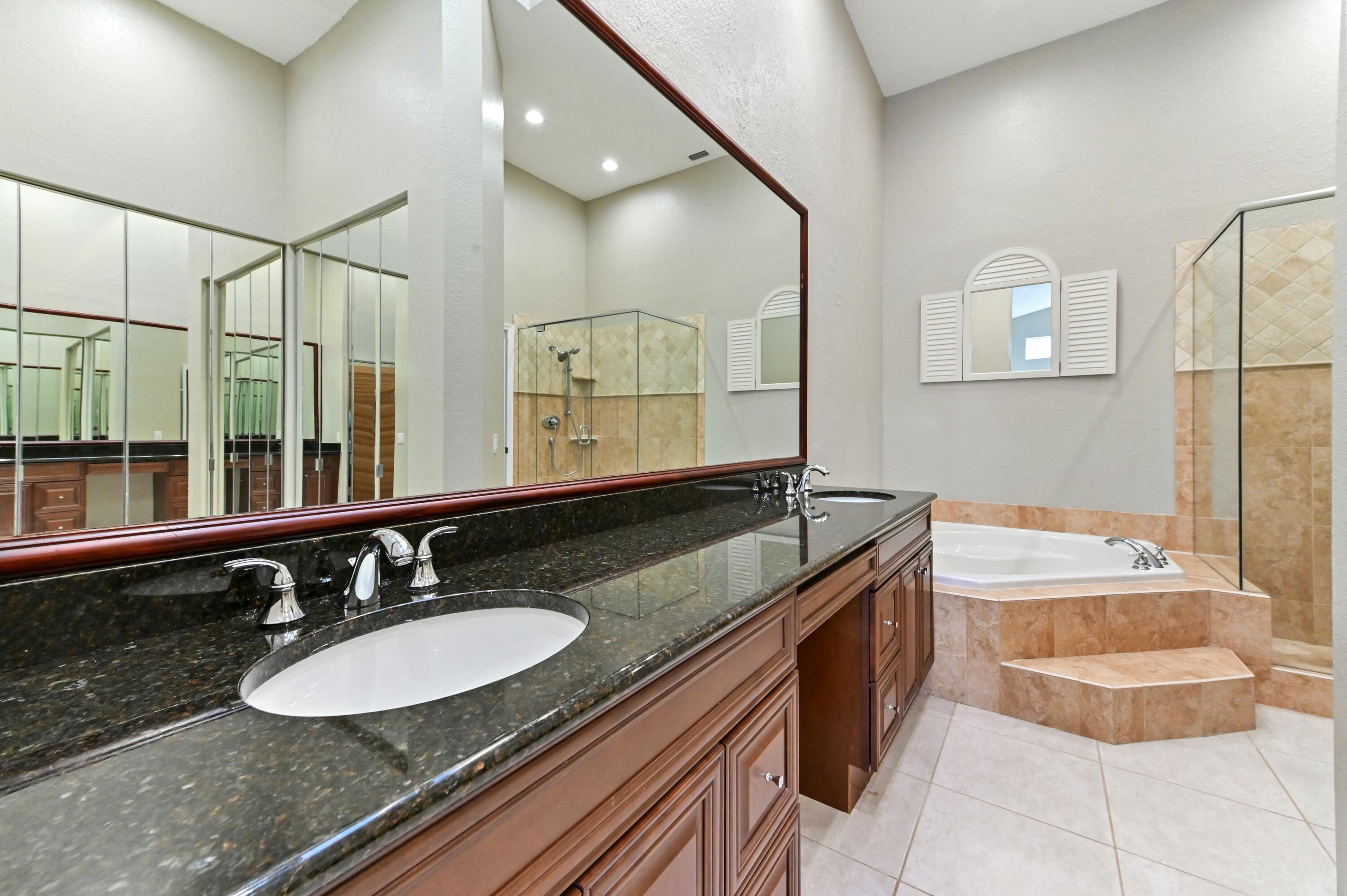 17272 Hampton Boulevard Boca Raton, FL 33496 - Photo 23 of 33 a bathroom with a granite countertop double vanity sink and a mirror