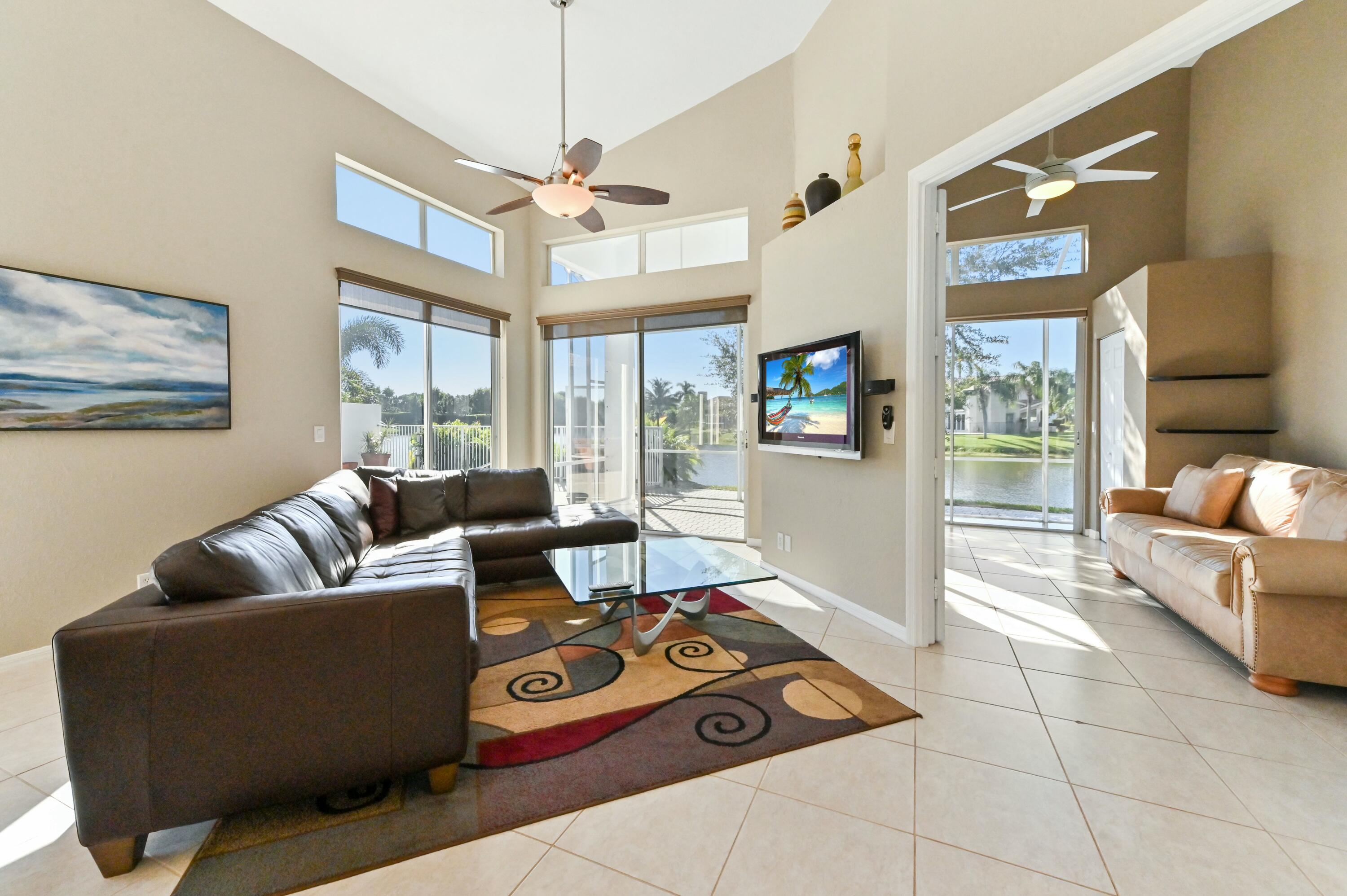 17272 Hampton Boulevard Boca Raton, FL 33496 - Photo 7 of 33 a living room with furniture and a flat screen tv
