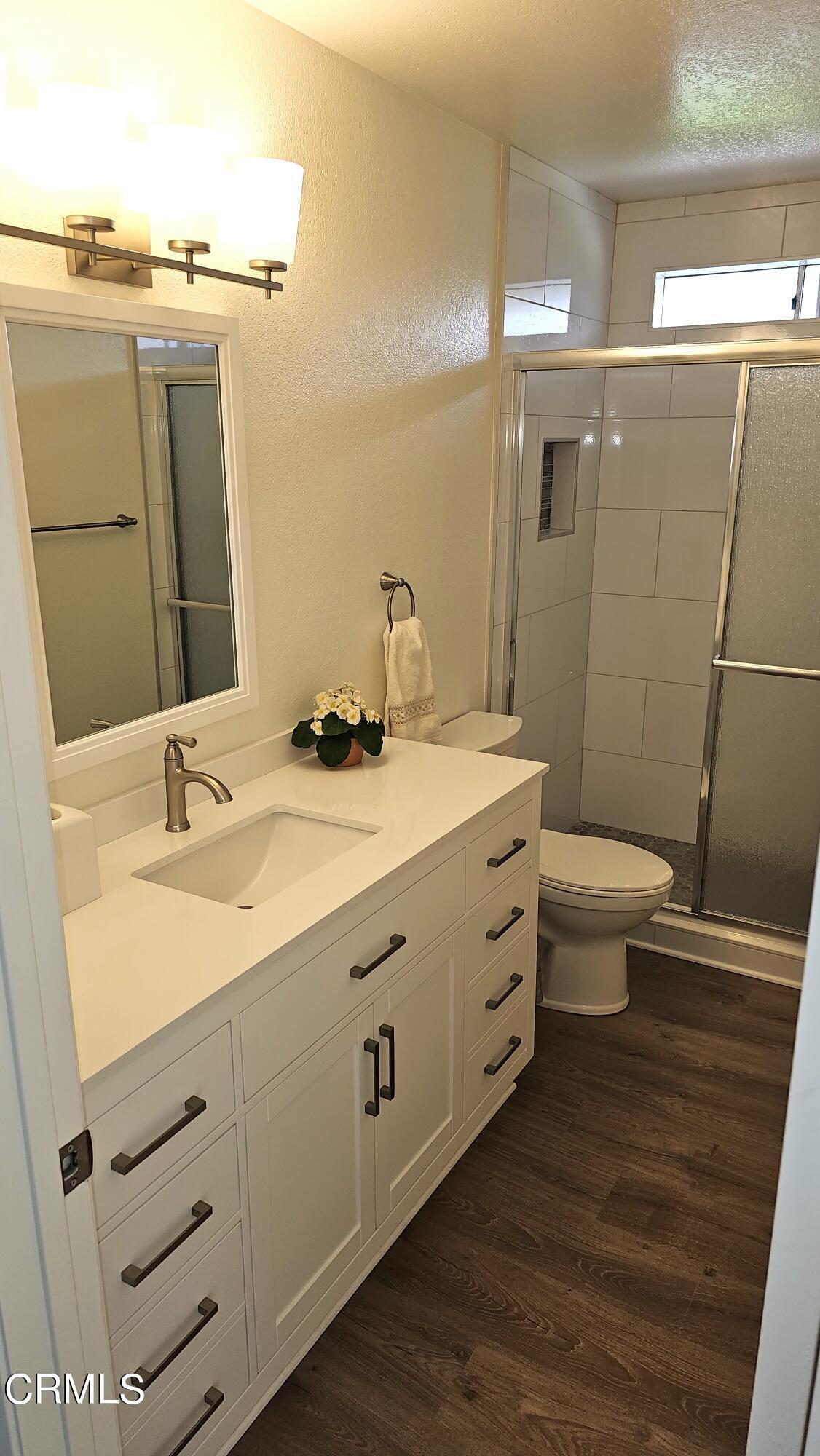 Undisclosed Address Oxnard, CA 93036 - Photo 11 of 22 a bathroom with a double vanity sink and a toilet