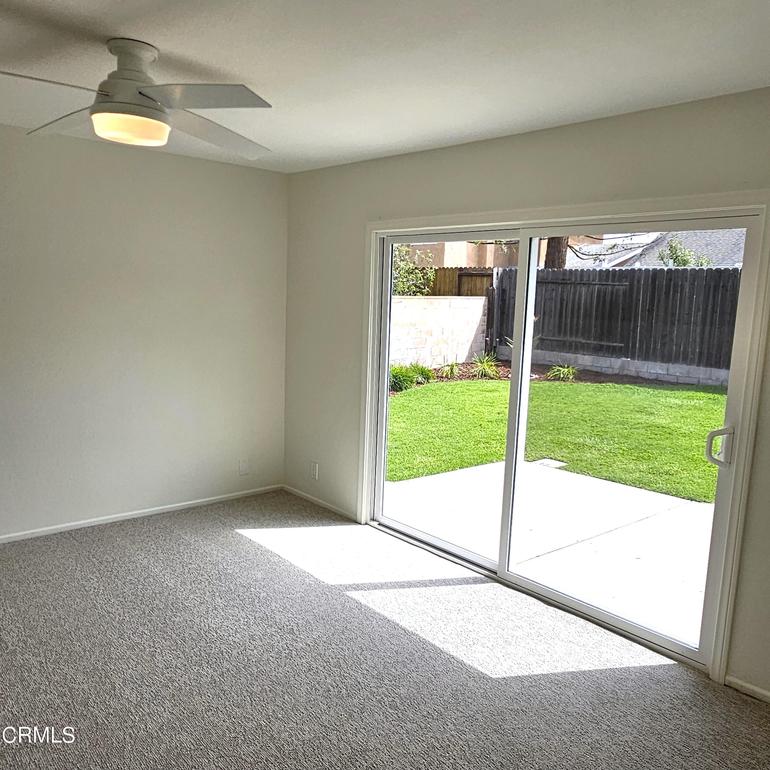 Undisclosed Address Oxnard, CA 93036 - Photo 16 of 22 a view of an empty room with wooden floor and glass door
