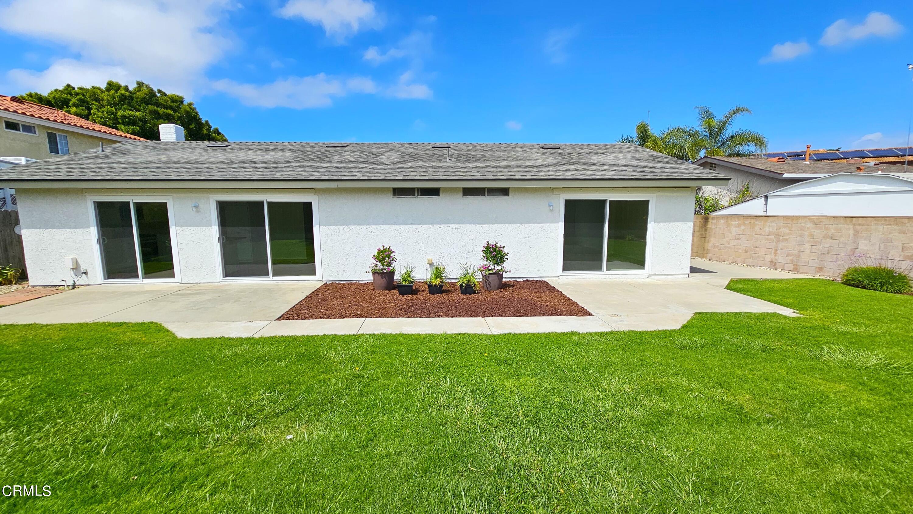 Undisclosed Address Oxnard, CA 93036 - Photo 17 of 22 a view of a house with a yard and potted plants