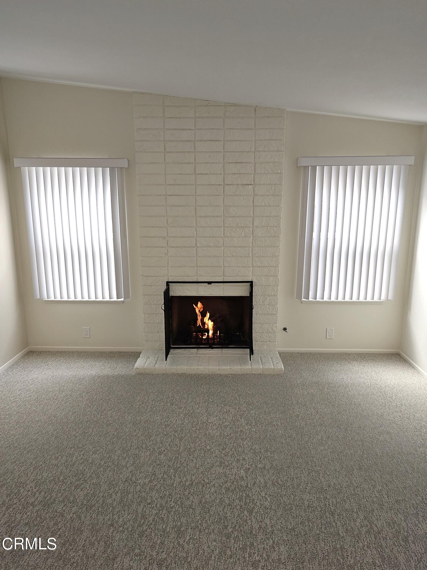 Undisclosed Address Oxnard, CA 93036 - Photo 3 of 22 an empty room with windows and fireplace