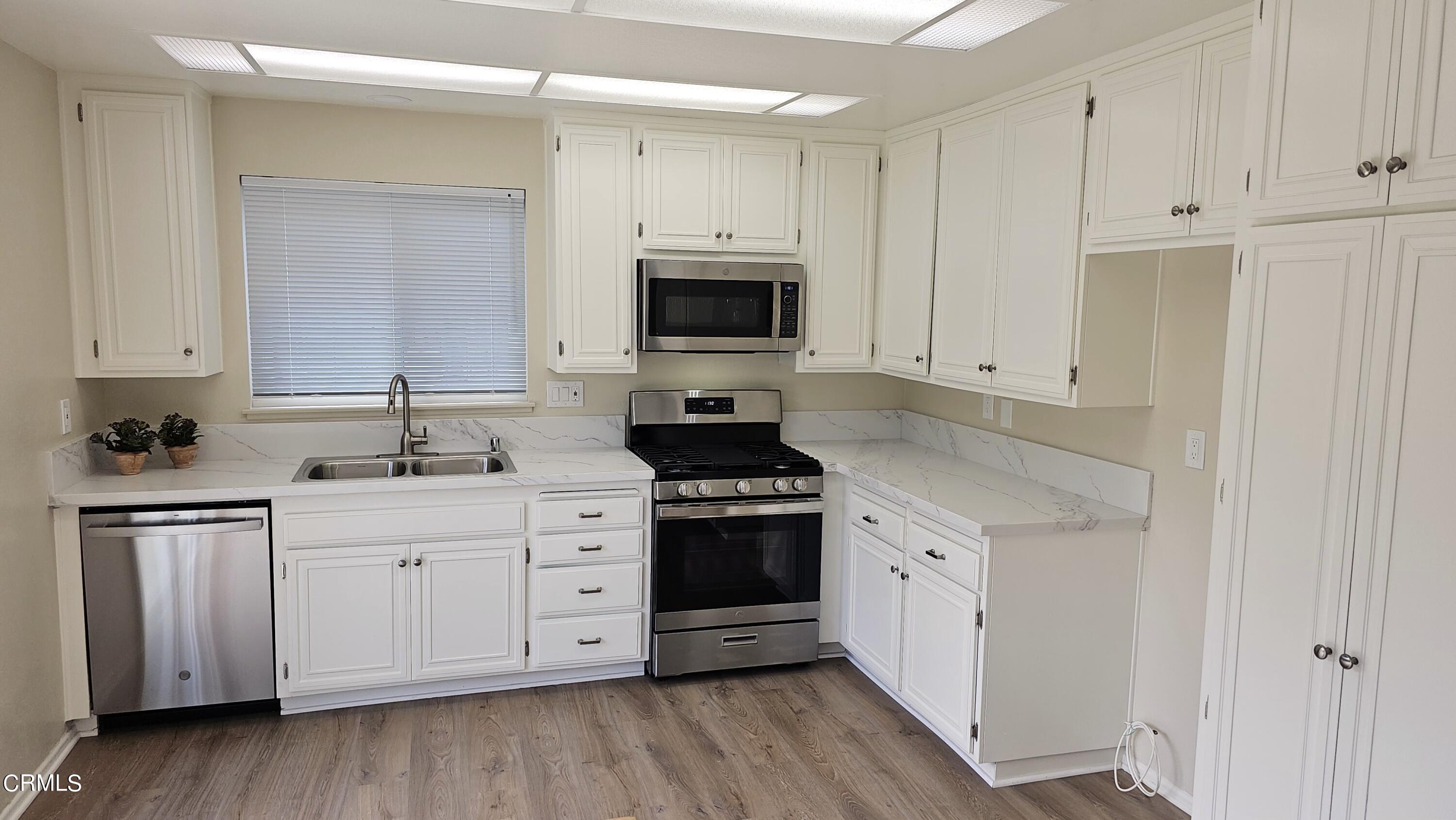 Undisclosed Address Oxnard, CA 93036 - Photo 5 of 22 a kitchen with white cabinets and a stove