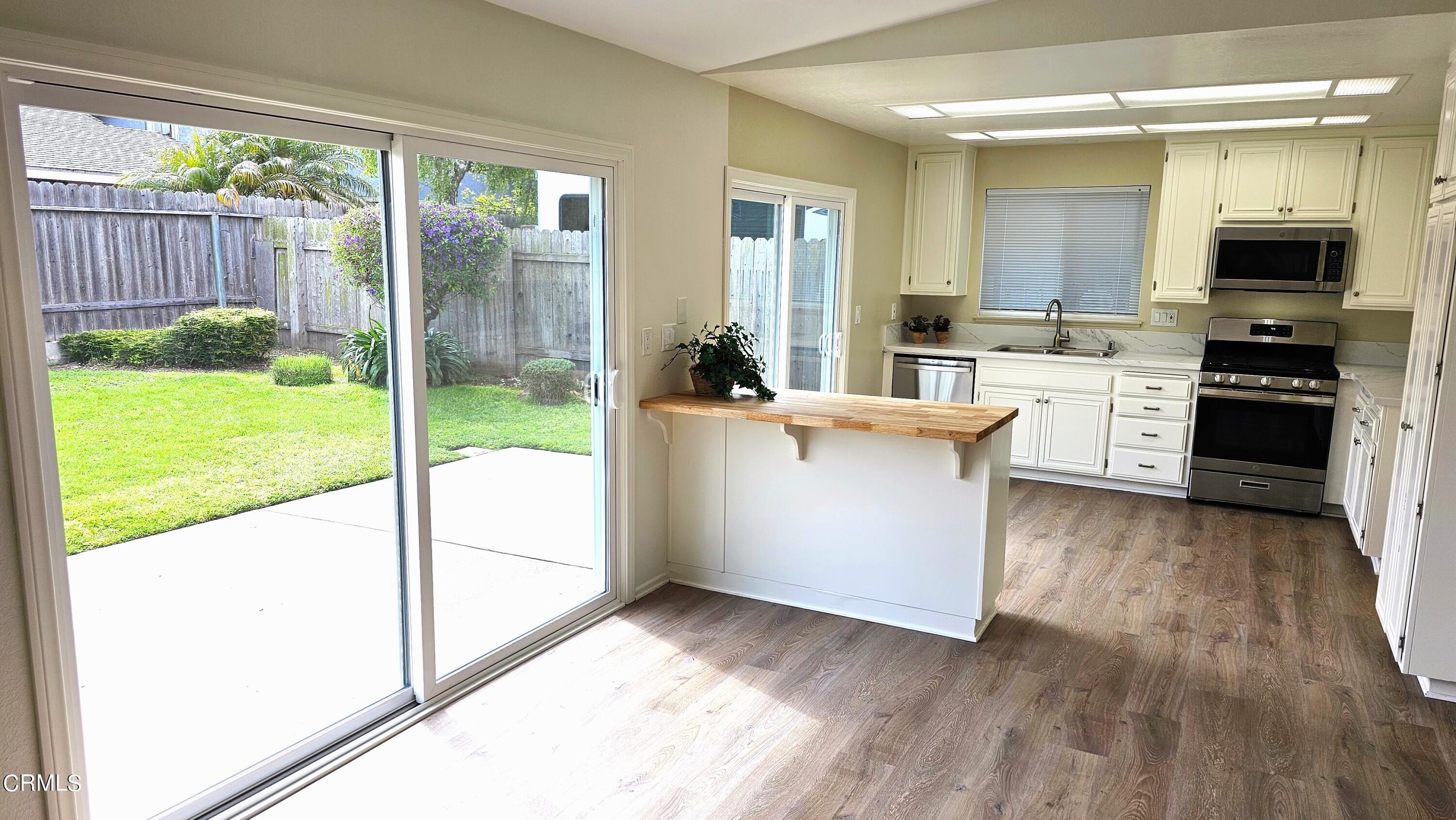 Undisclosed Address Oxnard, CA 93036 - Photo 6 of 22 a view of a kitchen with kitchen island a large window a sink and a counter top space