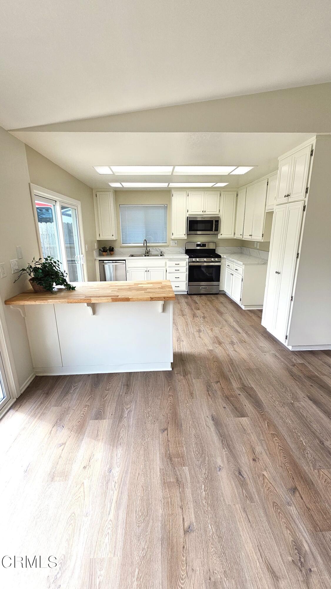Undisclosed Address Oxnard, CA 93036 - Photo 8 of 22 a kitchen with a sink and a stove top oven
