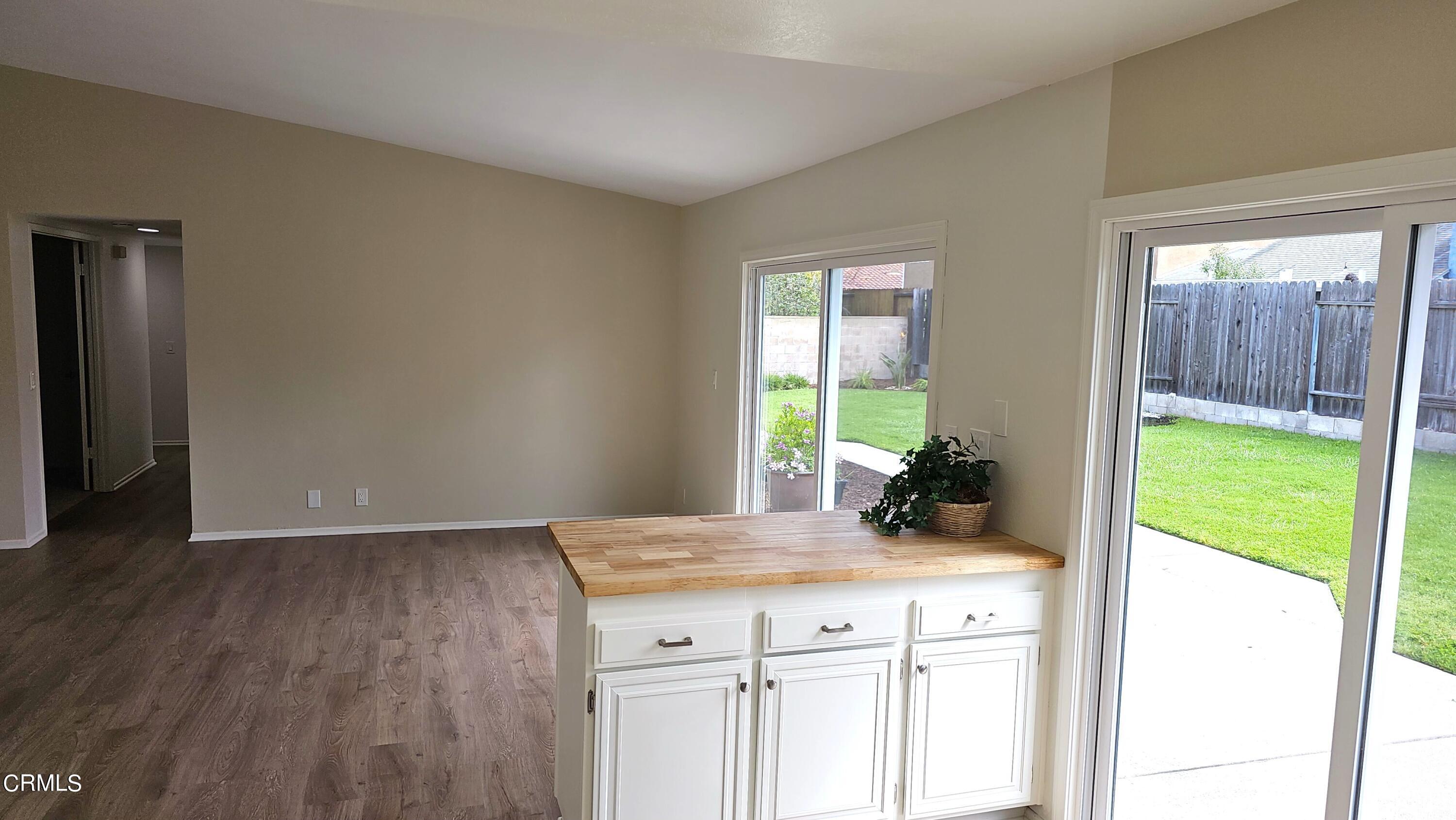 Undisclosed Address Oxnard, CA 93036 - Photo 9 of 22 a kitchen with a sink and wooden cabinets