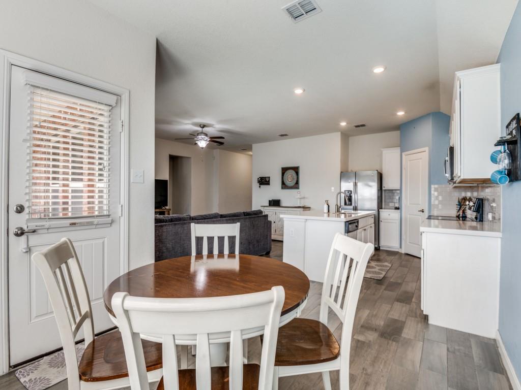 115 Garner Court Forney, TX 75126 - Photo 12 of 26 a kitchen with a dining table chairs and refrigerator
