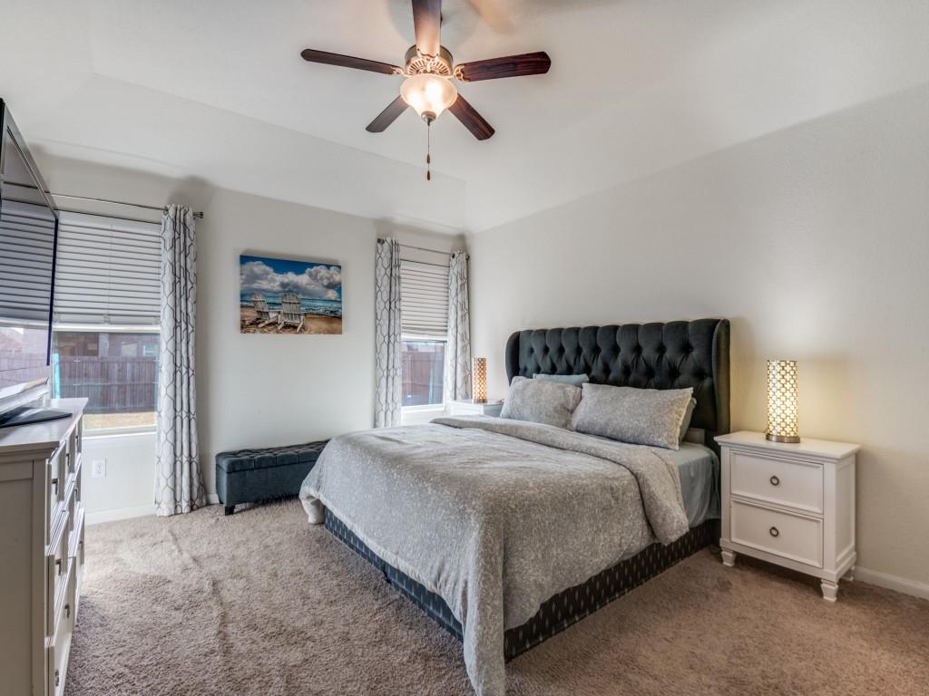 115 Garner Court Forney, TX 75126 - Photo 14 of 26 a bedroom with a bed and a chandelier