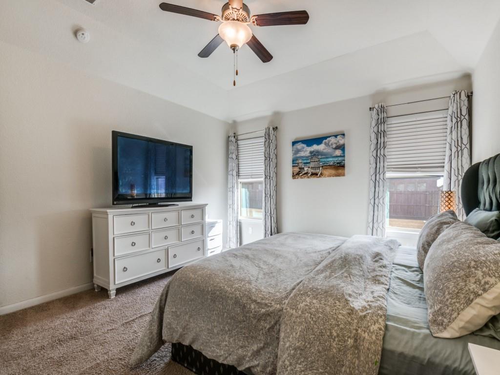 115 Garner Court Forney, TX 75126 - Photo 15 of 26 a bedroom with a bed and a flat screen tv