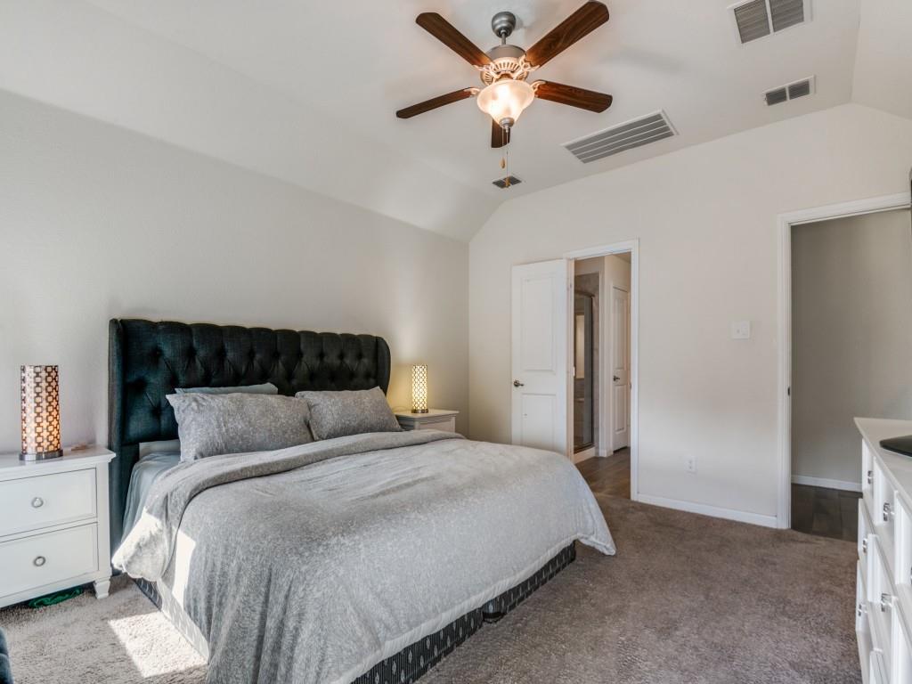115 Garner Court Forney, TX 75126 - Photo 16 of 26 a bedroom with a large bed and a ceiling fan