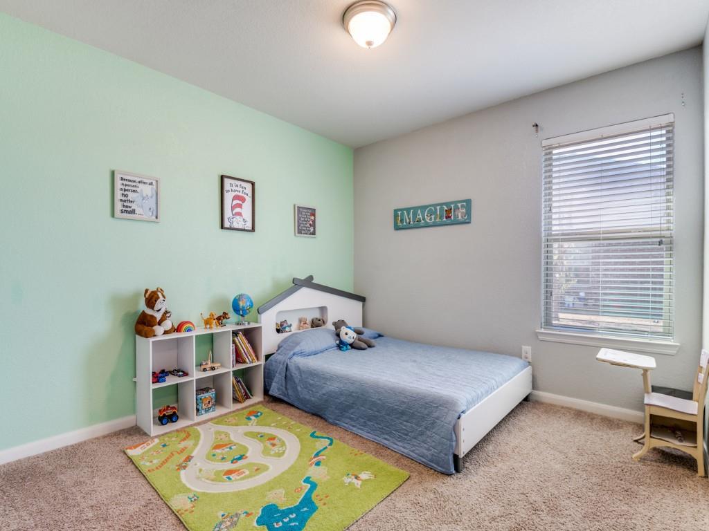 115 Garner Court Forney, TX 75126 - Photo 19 of 26 a bedroom with a bed and a window
