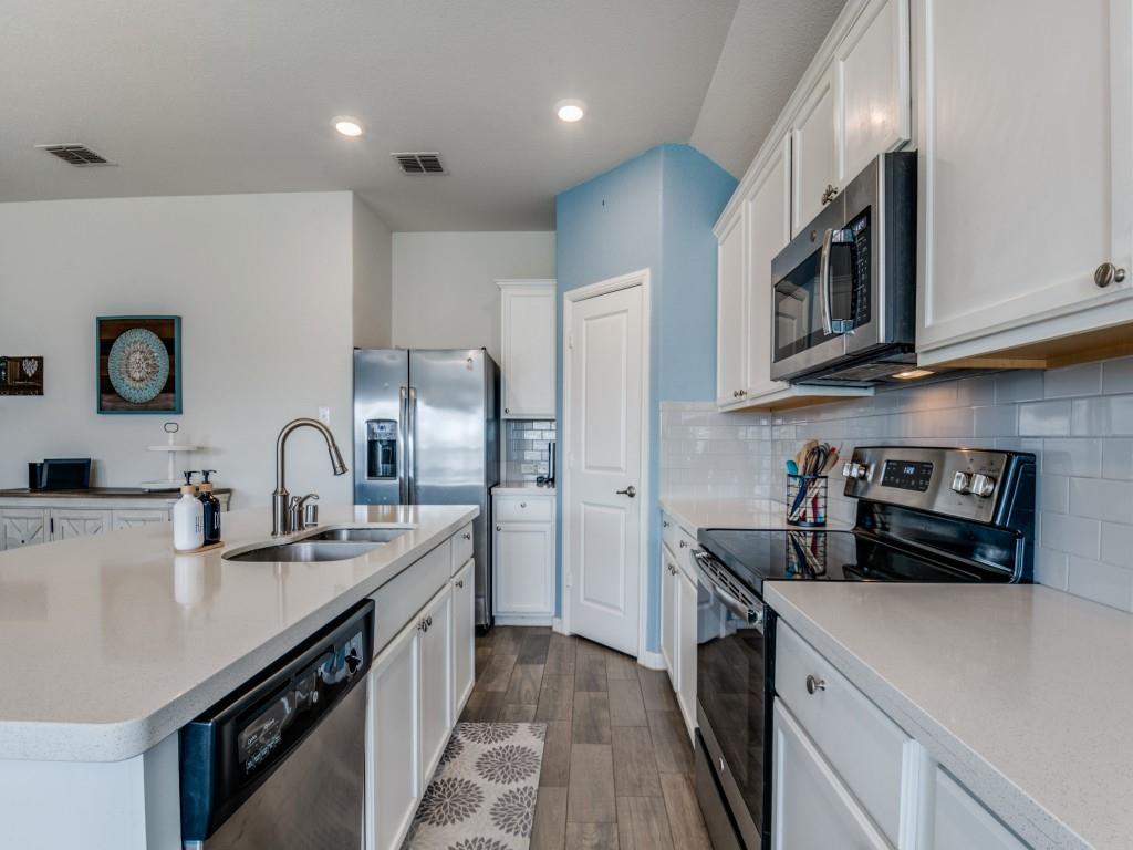 115 Garner Court Forney, TX 75126 - Photo 10 of 26 a kitchen with stainless steel appliances granite countertop a sink a stove and cabinets