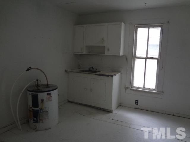 1508 Poole Road Raleigh, NC 27610 - Photo 6 of 8 a room with a stove a sink and a window