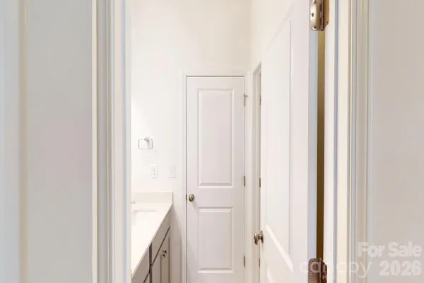 a view of a bathroom from a corridor